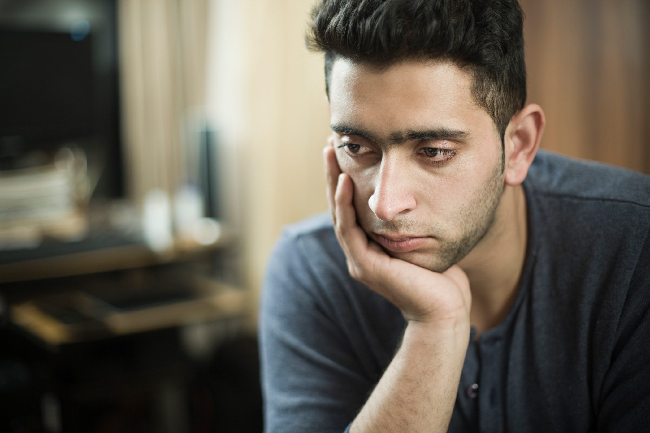 Young man looking thoughtful and melancholy